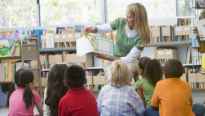 An educator reads a story to learners.